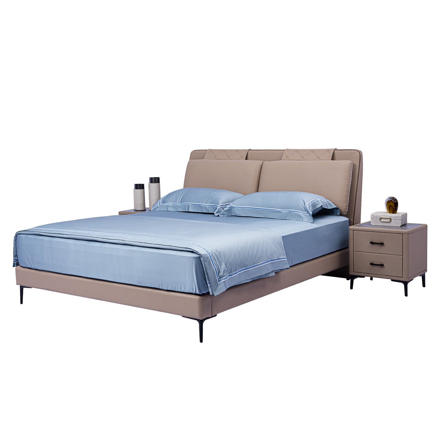 Light brown upholstered bed frame with cushioned headboard and blue bedding next to a brown bedside table with a golden clock and books