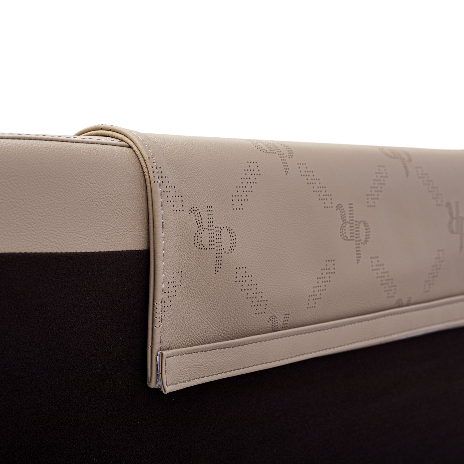 Beige leather bed frame headrest with DeRUCCI brand logo pattern and detailed stitching