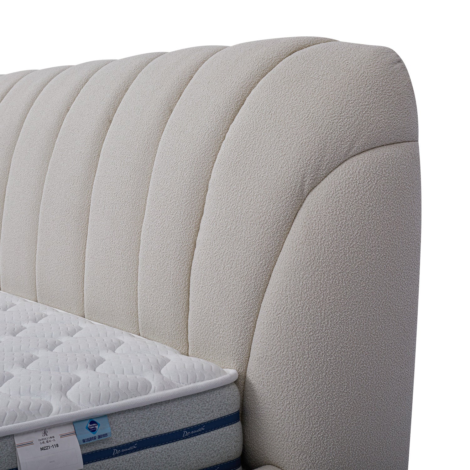 DeRUCCI BOC1 - 015 bed frame close-up showing plush white upholstered headboard with vertical tufting and mattress corner