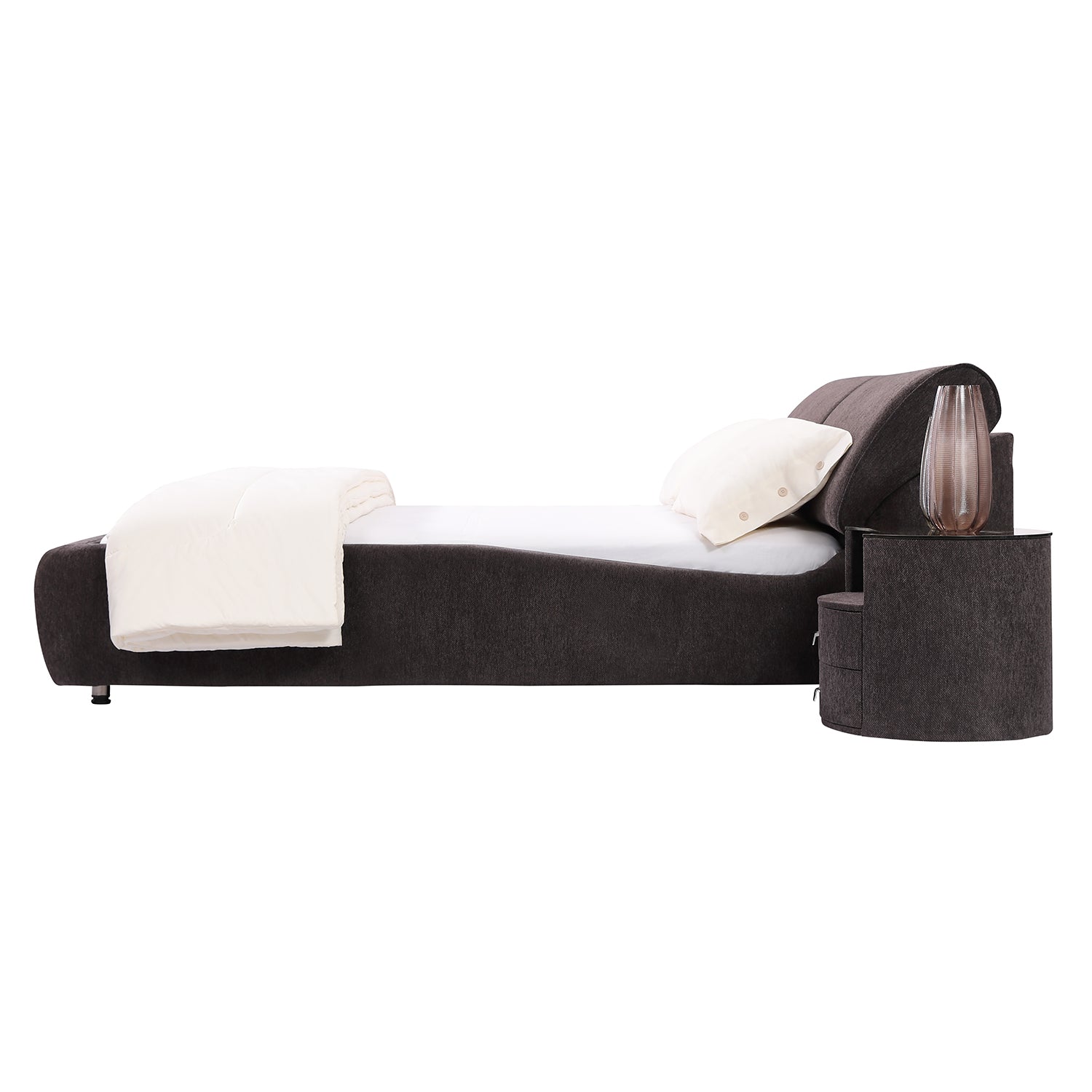 Modern dark fabric bed frame BZZ4 - 117 by DeRUCCI with thick cushion headboard, white bedding, and adjacent nightstand with lamp.