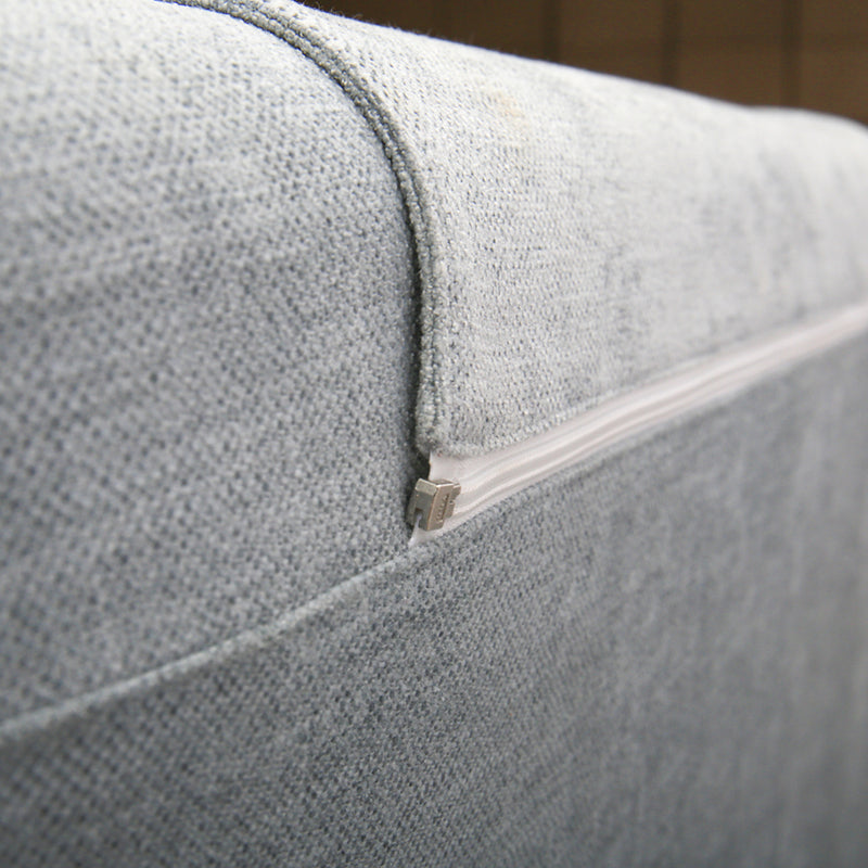 Close-up of DeRUCCI light grey fabric bed frame with a removable and washable double-sided cushion and white zipper