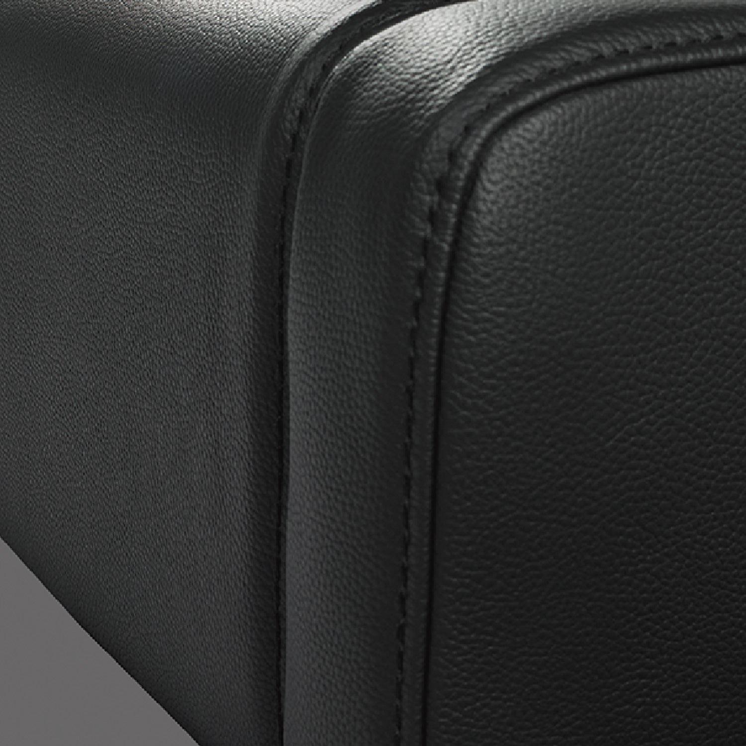 Close-up of black cow leather bed frame corner with quality stitching