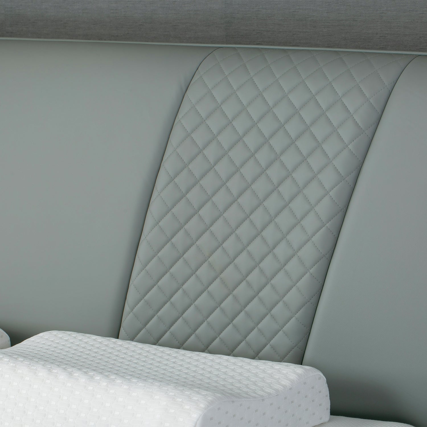 Quilted leather headboard of Bed Frame BOC1 - 005 by DeRUCCI, featuring a diamond pattern and white pillows in the foreground.