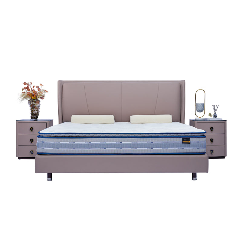 DeRUCCI Bed Frame BOC1 - 018 with a beige plush headboard and blue mattress, accompanied by two bedside tables with decorations including a vase, books, and a reed diffuser.
