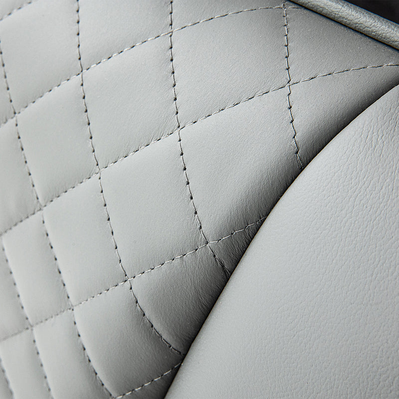 Quilted white leather texture with stitching details showcasing craftsmanship in DeRUCCI bed frames