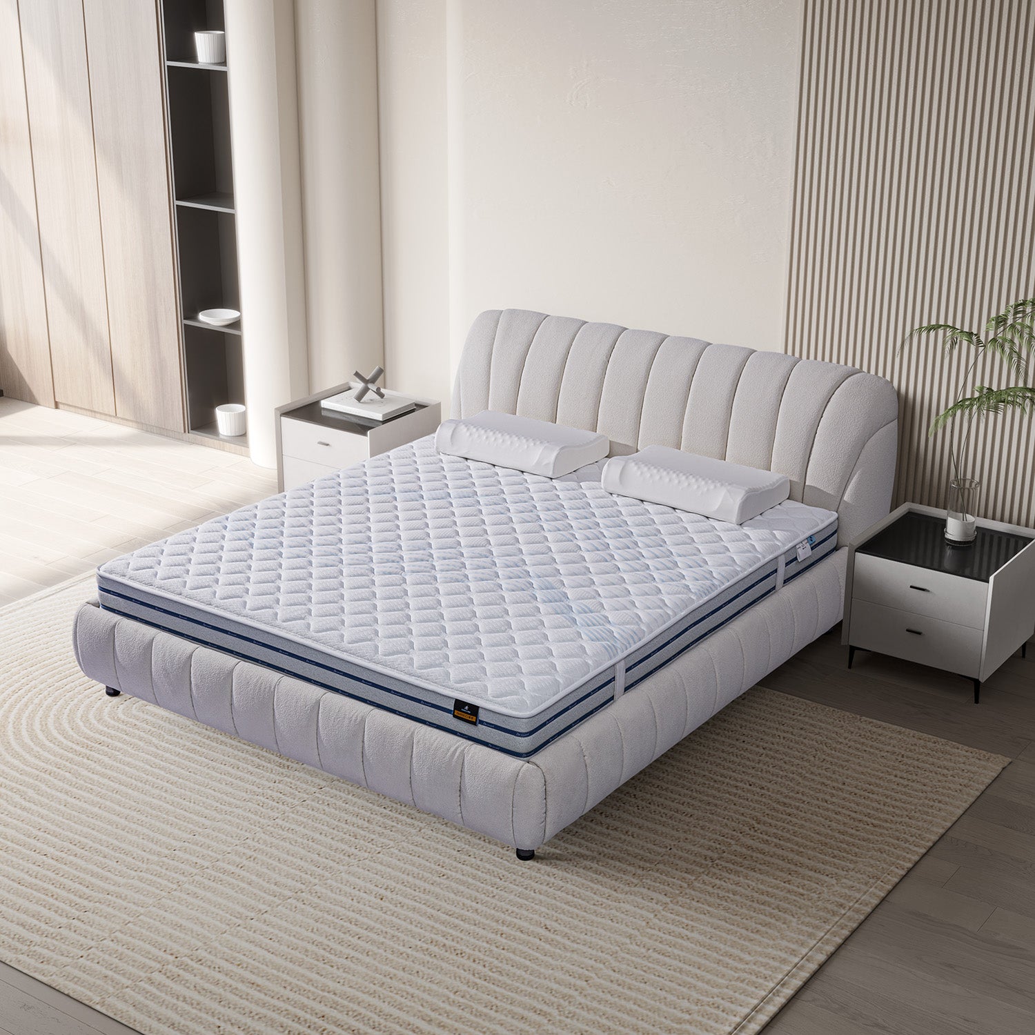 DeRUCCI's BOC1 - 015 bed frame with white fabric headboard and footboard, paired with a quilted mattress. Modern nightstands with lamps and decor items are placed on either side in a sunlit bedroom.