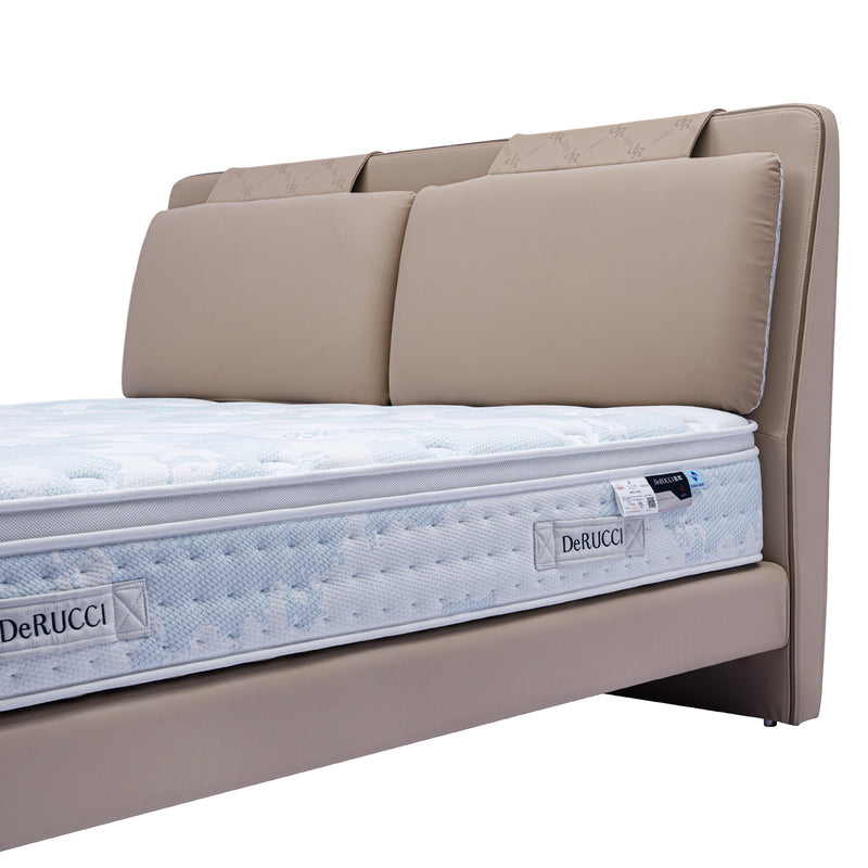 DeRUCCI bed frame BOC1-006 with beige upholstery and padded headboard cushions, featuring a branded DeRUCCI mattress displaying the brand’s commitment to quality and comfort.