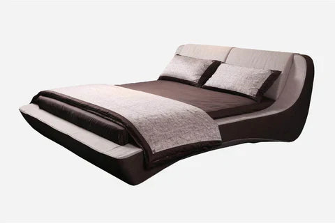 A modern bed with a unique curved design, upholstered in dark brown and beige fabric