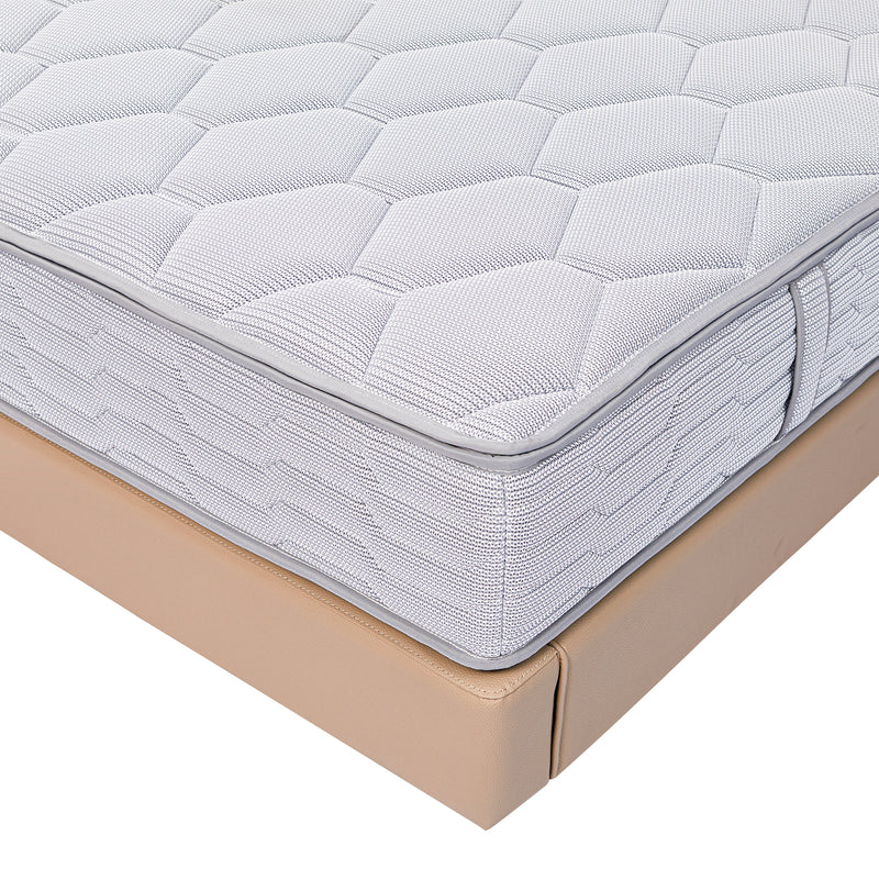 Close-up view of a white quilted mattress with geometric patterns on a beige DeRUCCI bed frame, showcasing quality craftsmanship and attention to detail.