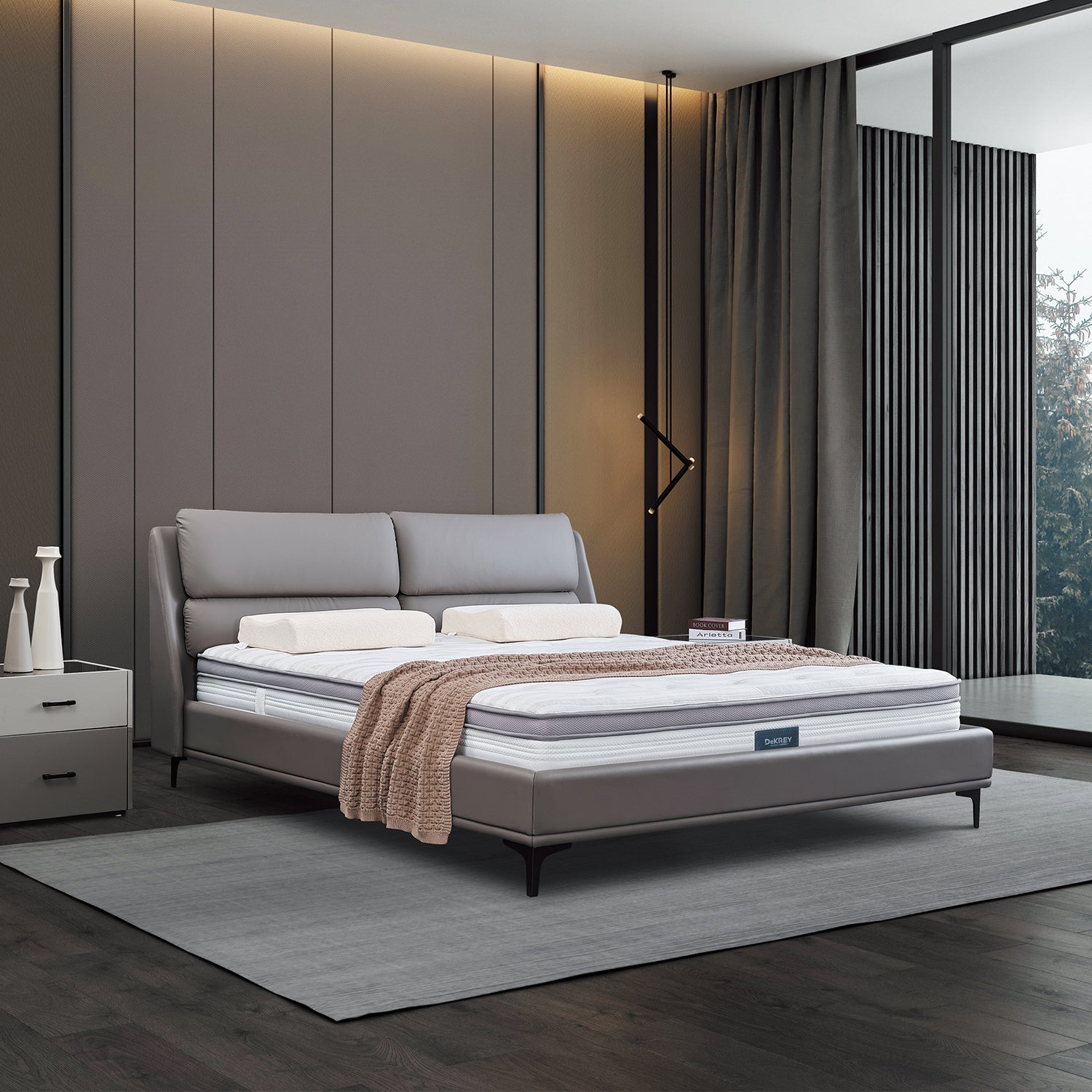 DeRUCCI Bed Frame BOC1-019 in a stylish modern bedroom with grey leather upholstery, white pillows, a white mattress, brown throw blanket, grey area rug, grey accent wall, dark wood floors, and black floor lamp.