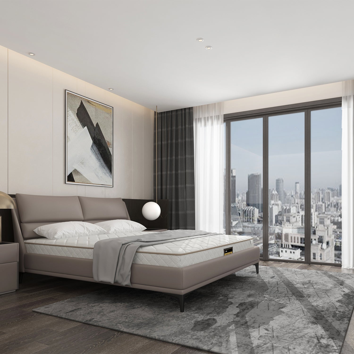 Modern bedroom with grey upholstered bed frame, mattress, grey bedding, large window with city views, bedside table with lamp, grey area rug, and abstract art piece on wall.